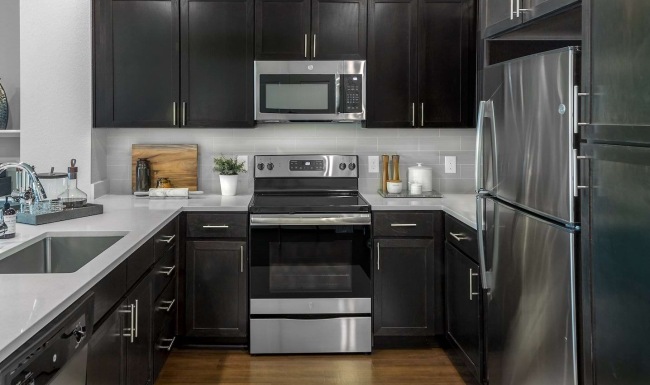 a kitchen with black cabinets